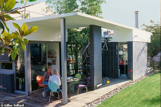 Extension moderne avec toiture terrasse et patio végétalisé